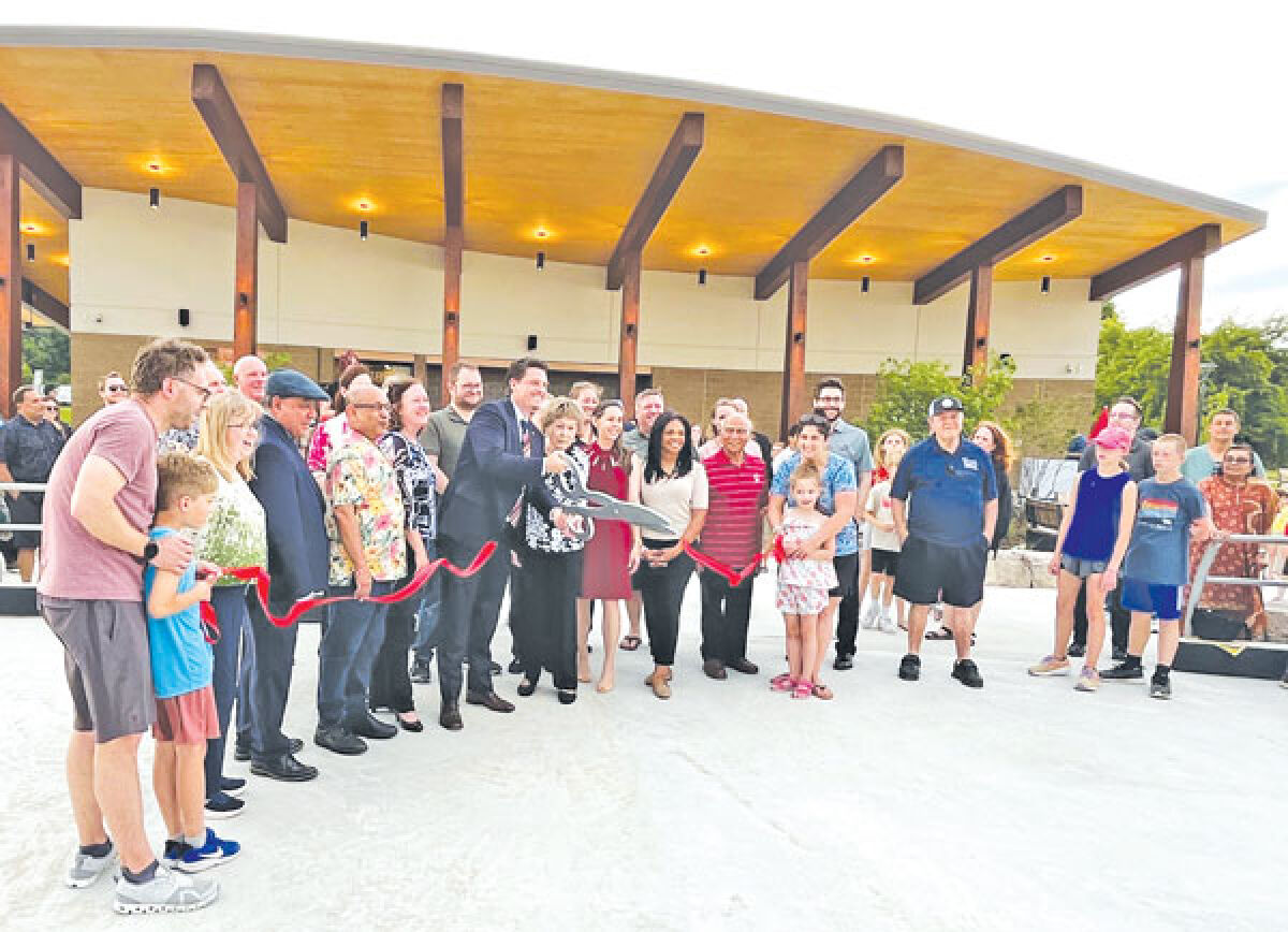  Troy Mayor Ethan Baker and former Mayor Jeanne M. Stine, along with members of Troy’s city government and the community, cut the ribbon for the new rink and pavilion June 13.  