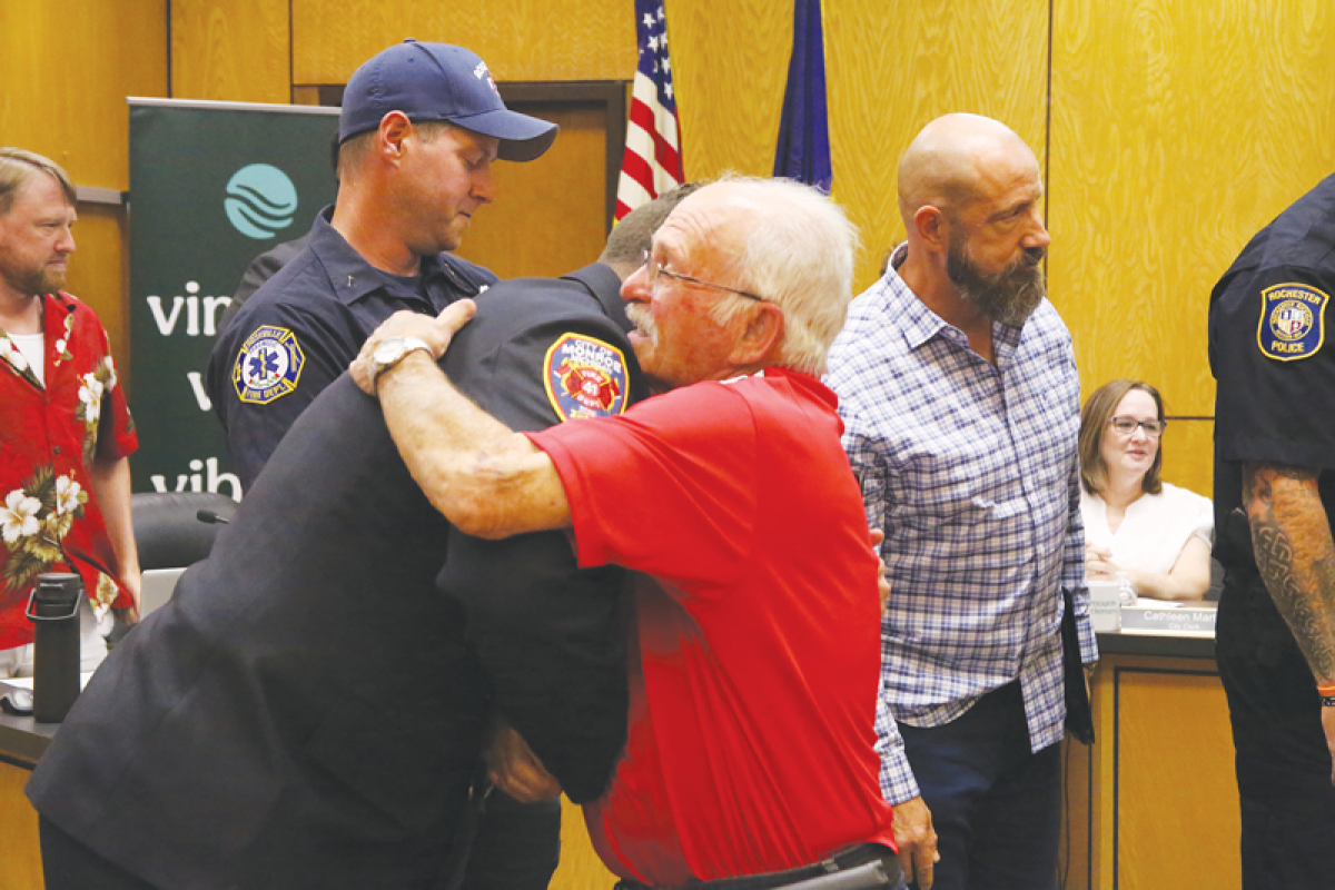  Rich Mazzella hugs Derek Kull, Monroe Fire Department captain, at the July 1 Mount Clemens City Commission meeting. Kull and three other first responders were recognized for saving Mazzella’s life after he collapsed during a hockey game at the Mount Clemens Ice Arena earlier this year.  