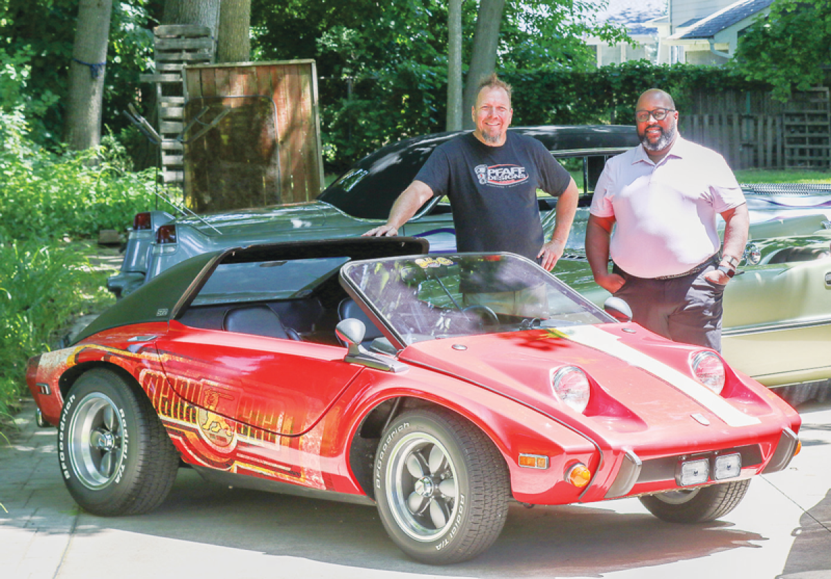  Madison Heights City Councilman Quinn Wright, right, meets with Murray Pfaff, of Pfaff Designs in Royal Oak, to plan the upcoming car show and cook-off this fall, Revin’ in the Heights. Pfaff customizes cars and has been featured in magazines and car-build TV shows. The ride seen here is a 1974 Meyers Manx SR2. 