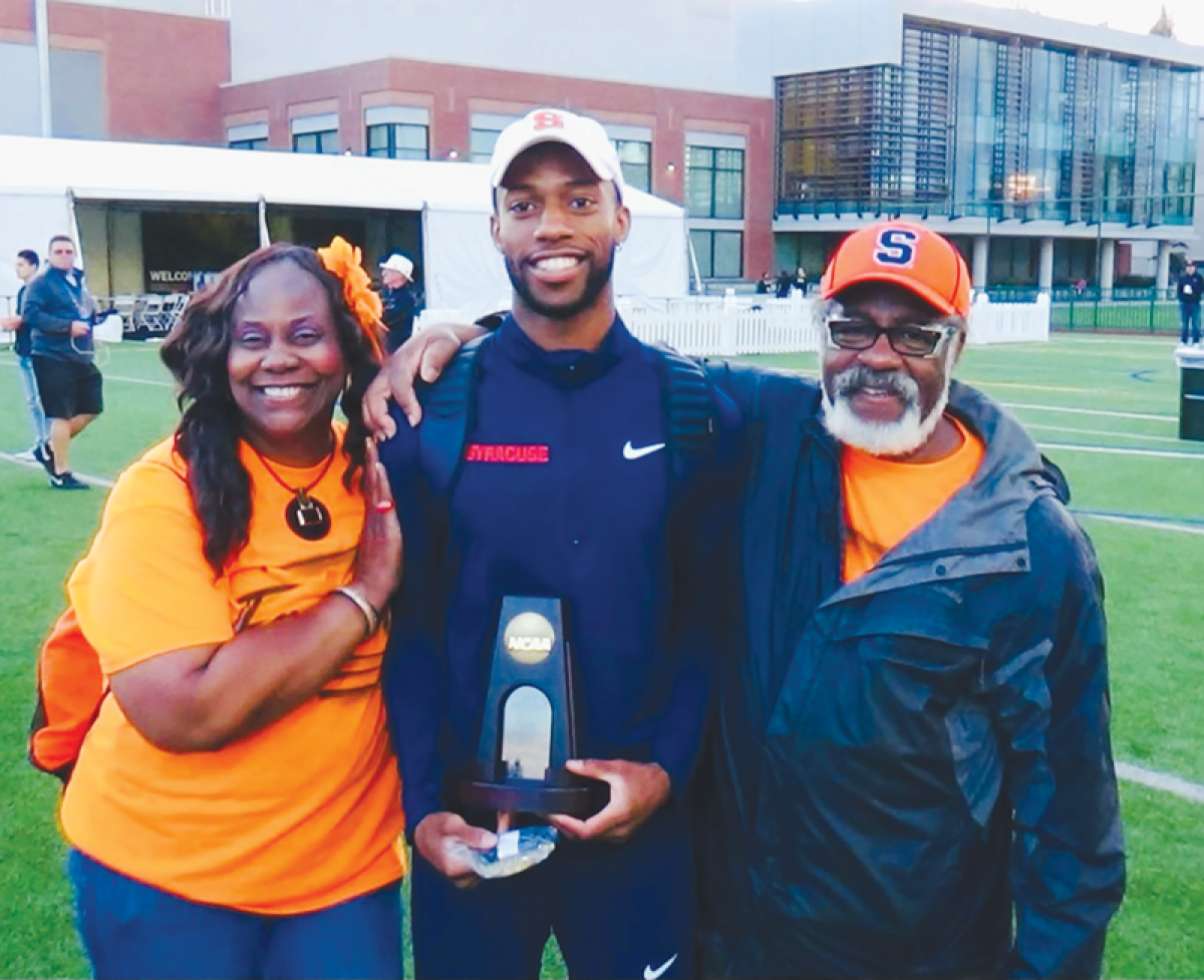  Freddie Crittenden stands with his mother, Dr. Cassandra Crittenden, and father, Freddie Crittenden. 