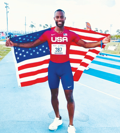  Freddie Crittenden holds the United States flag after a race at the 2022 North American, Central American and Caribbean Championships in the Bahamas. The Utica High School alumnus will compete for the United States at the Paris Olympics. 