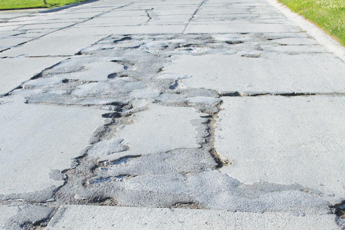  This photo shows a particularly rough section of Commerce Road in the Fraser Industrial Park. The city is set to get $4 million in state funding to put toward the repair of roads like this in the region. 