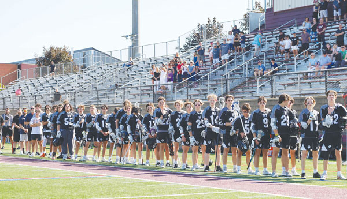  Royal Oak-Berkley M1 boys lacrosse stands together for the national anthem before a game this season. 