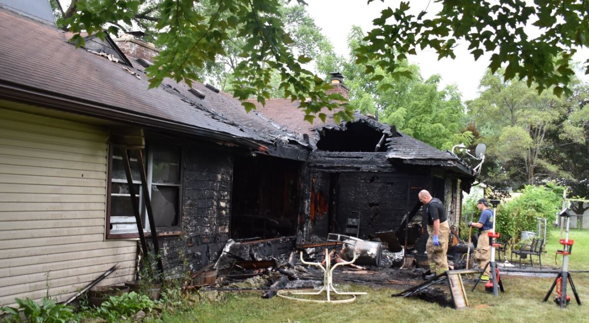  Firefighters examine the scene of a July 12 house fire at 1561 E. Muir Ave. The blaze left the home totaled and two residents deceased. 