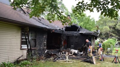  Firefighters examine the scene of a July 12 house fire at 1561 E. Muir Ave. The blaze left the home totaled and two residents deceased. 