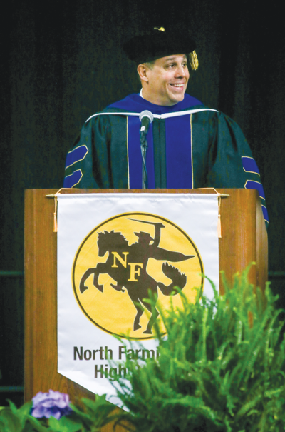  Christopher Delgado, the superintendent of Farmington Public Schools, addresses the 2024 graduates of North Farmington High School during their commencement ceremony June 9 at the USA Hockey Arena in Plymouth.   