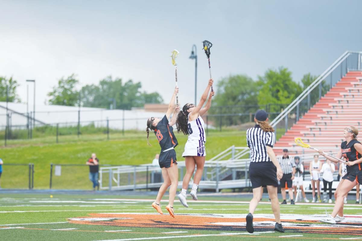  Bloomfield Hills senior Ella Lucia reaches up to gain control of the ball against a Brighton player. 