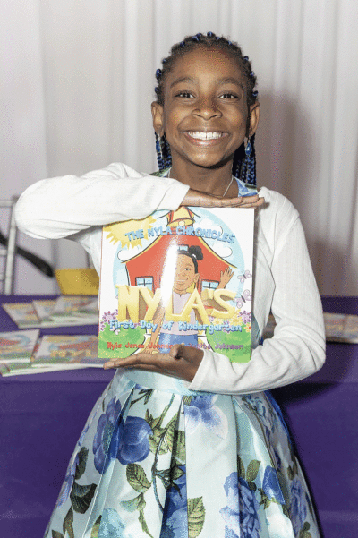  Nyla Johnson, of Oakland Township, shows off her book, “The Nyla Chronicles: Nyla’s First Day of Kindergarten.”   