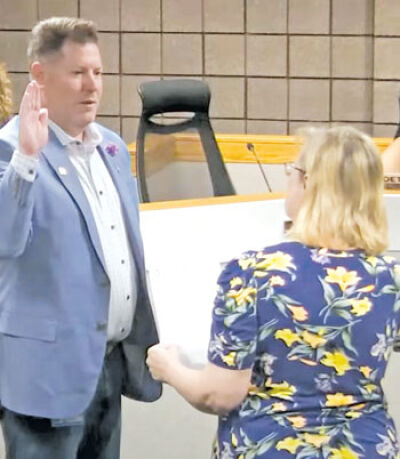  Fraser City Clerk August Gitschlag is sworn in by Cindi Greenia, the city’s previous clerk, at a June 13 Fraser City Council meeting. 