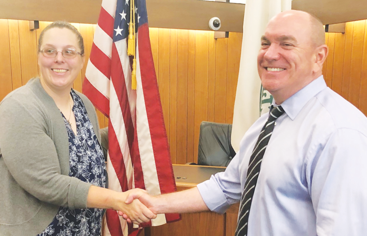  After being sworn in July 8, new Farms public safety officer Amanda McNeill shakes hands with Public Safety Director John Hutchins. 