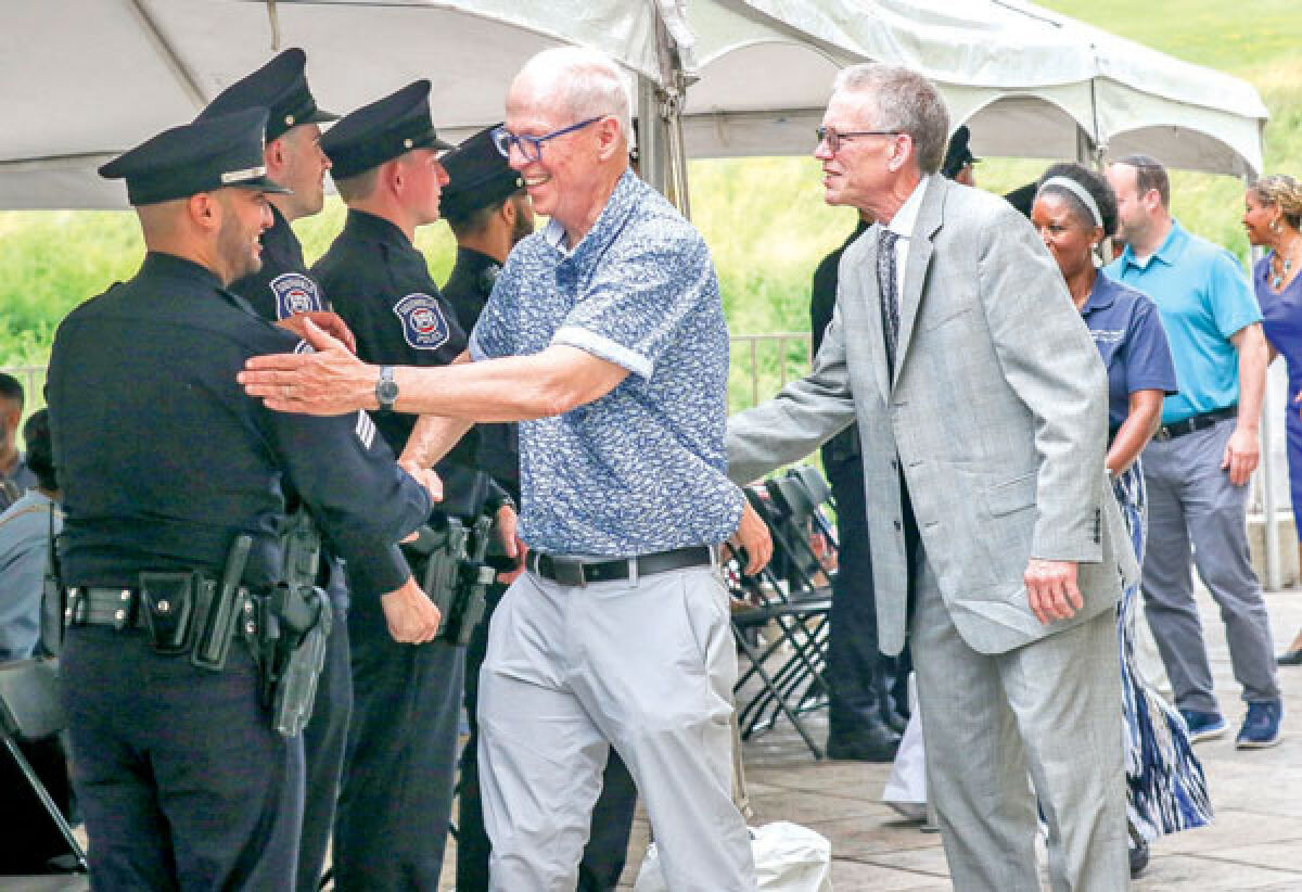  Southfield Mayor Ken Siver and Deputy City Administrator John Michrina shake hands with the nine newly sworn-in officers June 21. 