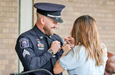  Sgt. Andrew Majewski had his sergeant badge pinned on by his wife, Riley Majewski. 