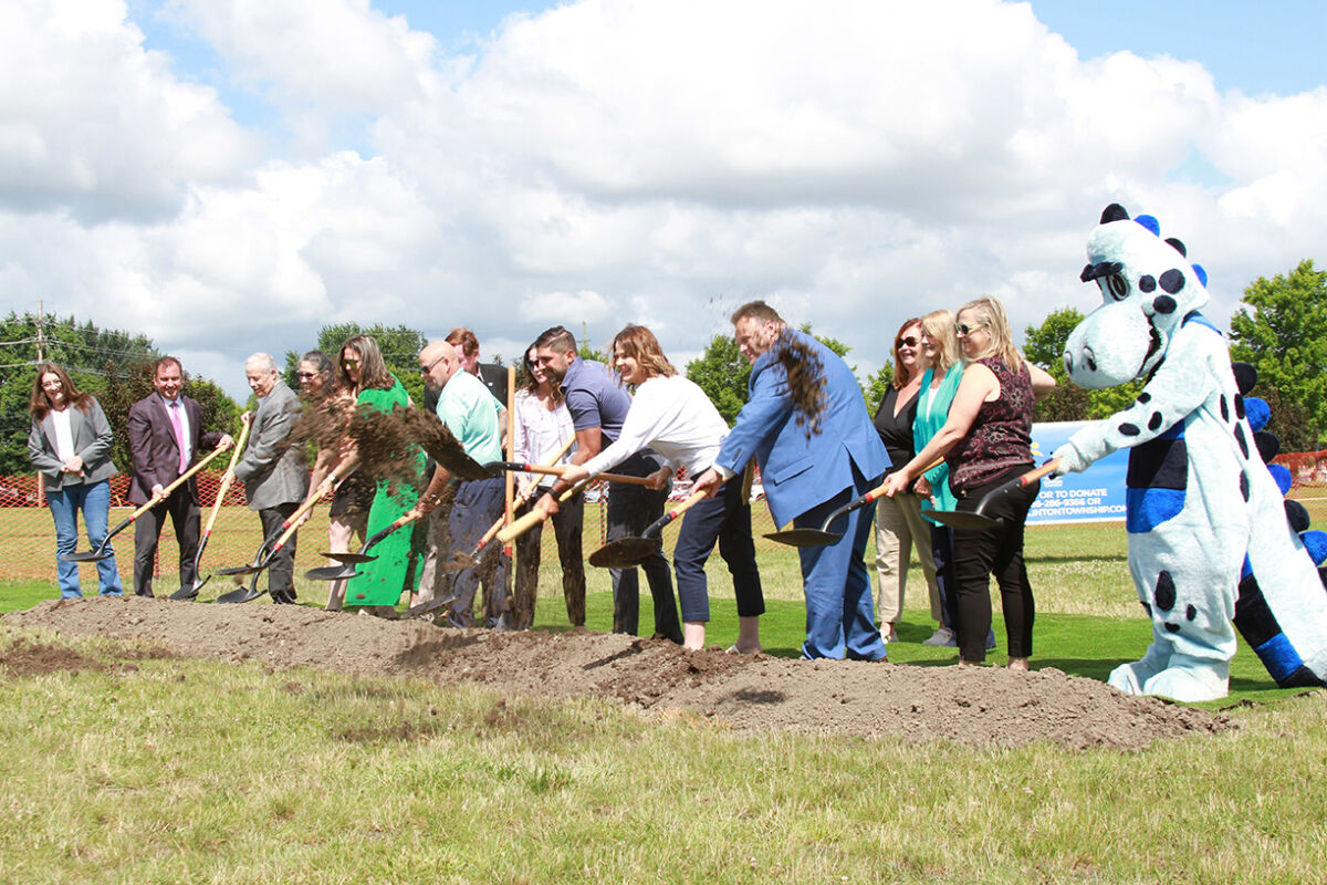  Elected officials and the Clinton Township Inclusive Playground Committee break ground at the new inclusive playground site  near the Clinton-Macomb Public Library main branch July 18. 