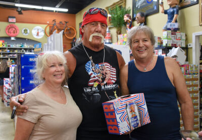  Hulk Hogan signs 12 packs of his new "Real American Beer" with fans Lisa and Marc Ludeman of Royal Oak at the Beverage Warehouse in Beverly Hills July 24. 