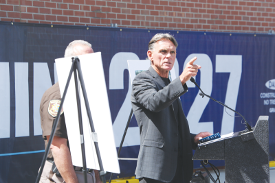  Macomb County Executive Mark Hackel speaks on July 19 during a “wall breaking” ceremony for the central intake and  assessment center project.  