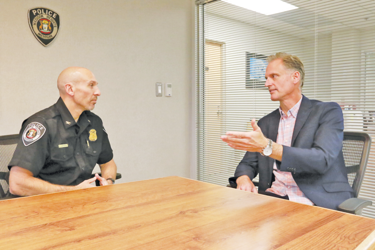  Madison Heights Police Chief Brent LeMerise, left, discusses the city’s Special Investigations Unit with Madison Heights City Councilman David Soltis at the Madison Heights Police Department on July 17. Five years ago, Soltis called for the unit’s return. There are now plans to expand it. 