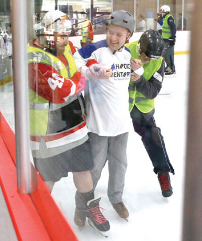  On-ice buddies assist disabled guests. 