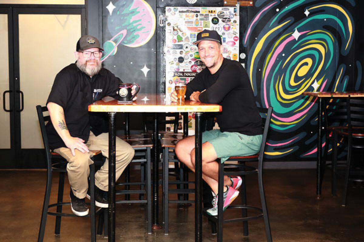  Head Brewer Leon Traczynski and owner Joe VanderMarliere of Baffin Brewery sit a table in the restaurant with mugs from their mug club. 