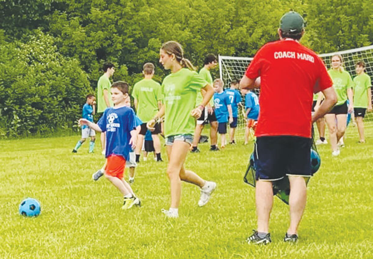  Buddy Soccer players and volunteers kick around the ball during a session. 