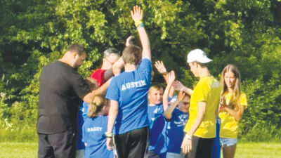  Buddy Soccer players, volunteers, and head coach Mario Iulianelli do the “Go Team” chant to end the session. 