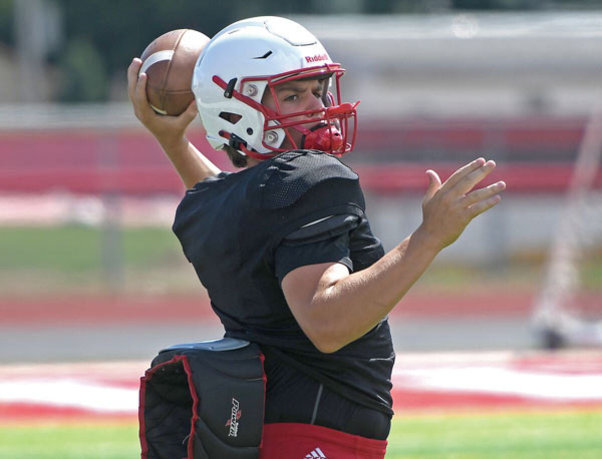  Junior quarterback Andrew Schuster looks to throw during a Clinton Township Chippewa Valley practice. 