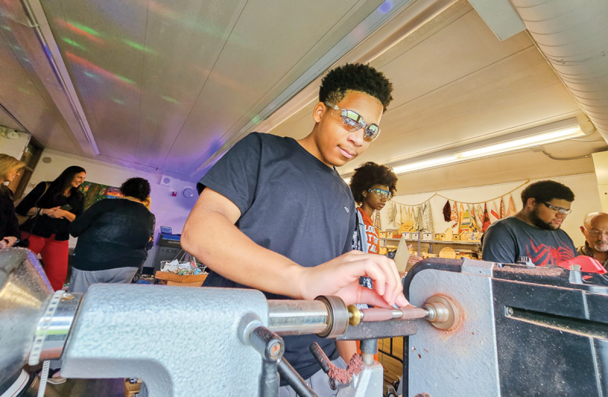  Sixteen-year-old Tristan Burton sands the wood on a pen while in class Aug. 6. 