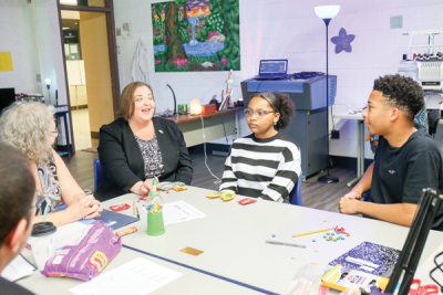  Warren Mayor Lori Stone, second from left, visits with Make It Work social worker Linda Hutchins, left, and students Madison Henderson, second from right, and Tristan Burton, right, on Aug. 6.   