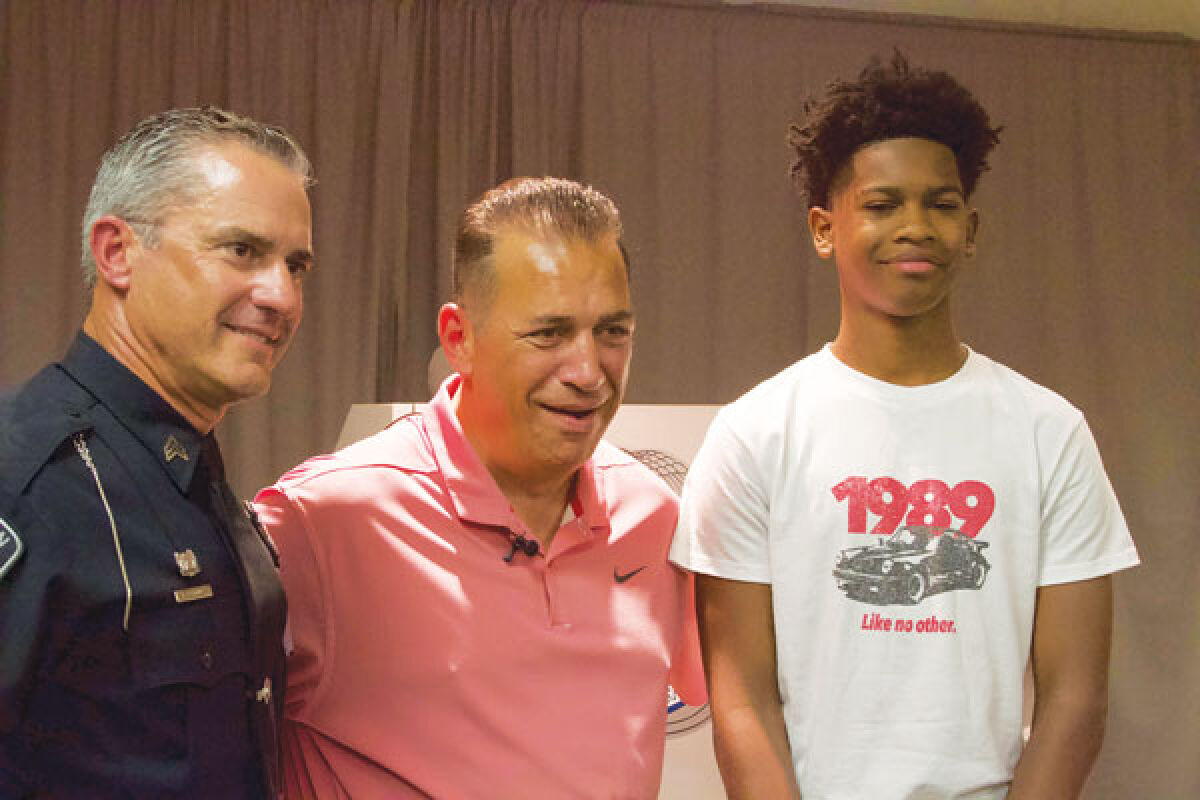  Clinton Township Police Sgt. Richard Collins, left, Eddie Fortuna, center, and Richard Blackwell pose for a picture following a press conference at the Clinton Township Police Department on Aug. 1. 