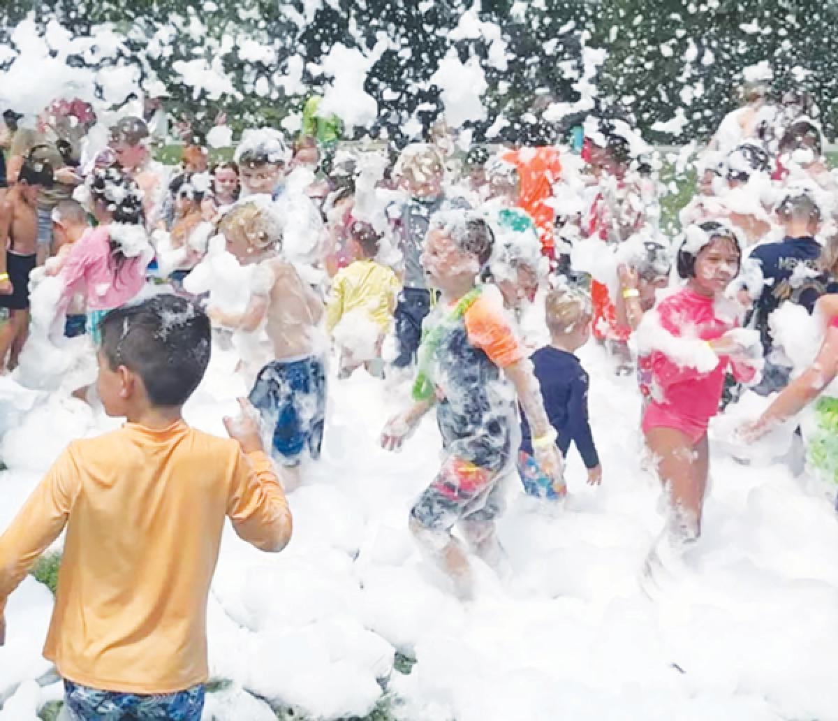  Children enjoy foam during a previous summer block party event. 