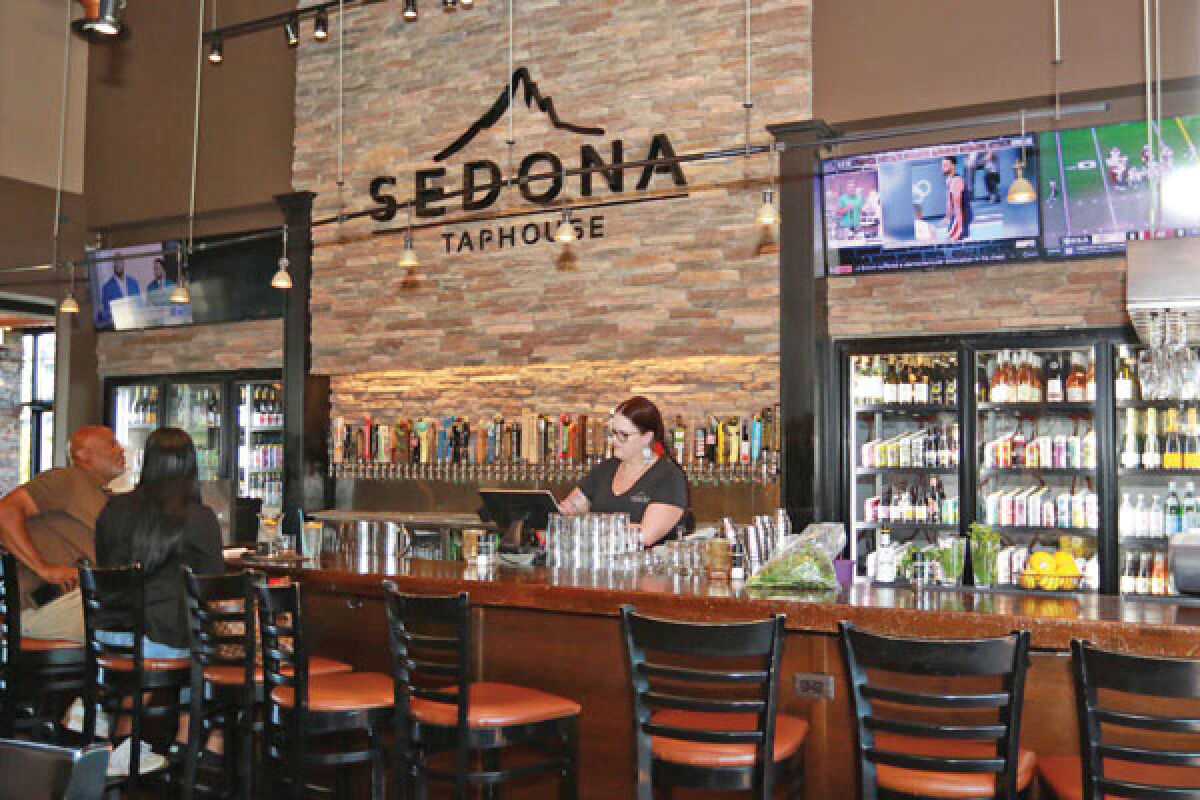  Patrons enjoy food and drinks at the bar at Troy’s Sedona Taphouse location at 198 E Big Beaver Road Aug. 12. 