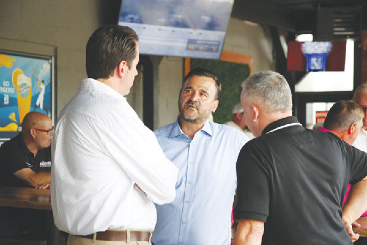  Macomb Township Supervisor Frank Viviano, center, speaks with Township Treasurer Leon Drolet, right, and Macomb County Commissioner Joe Sabatini, R-District 4, at a party for area Republicans at The Hub Sports Bistro on Thursday, Aug. 8. 