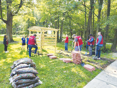  Workers install Clinton Township’s wind phone on  Aug. 22, which is located at the Civic Center Park near the bocce ball courts. 