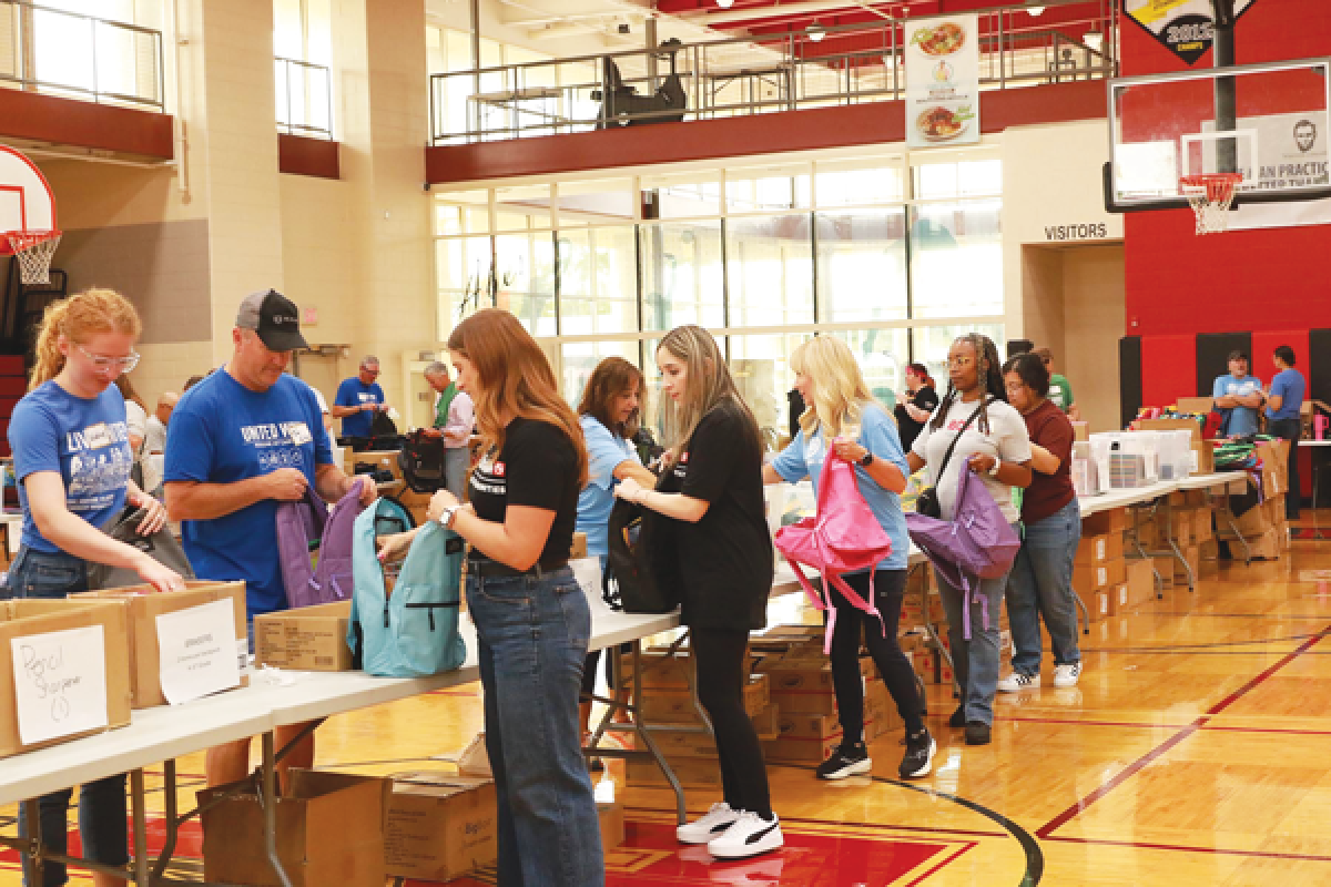  Volunteers from United Way for Southeastern Michigan and several local businesses pack backpacks with school supplies for local elementary, middle and high school students on Aug. 13.   