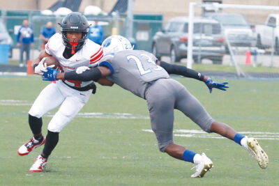  St. Clair Shores Lakeview senior Terrell McCurdy (#23) attempts to make a tackle on Roseville senior Herman Searcy. 