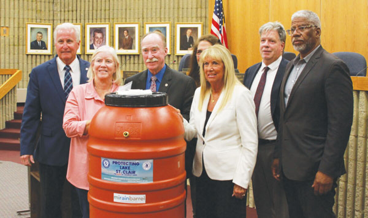  The Roseville City Council poses for a picture with Macomb County Public Works Commissioner Candice Miller Aug. 13 following her presentation about the city’s new rain barrel program. 