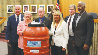  The Roseville City Council poses for a picture with Macomb County Public Works Commissioner Candice Miller Aug. 13 following her presentation about the city’s new rain barrel program. 