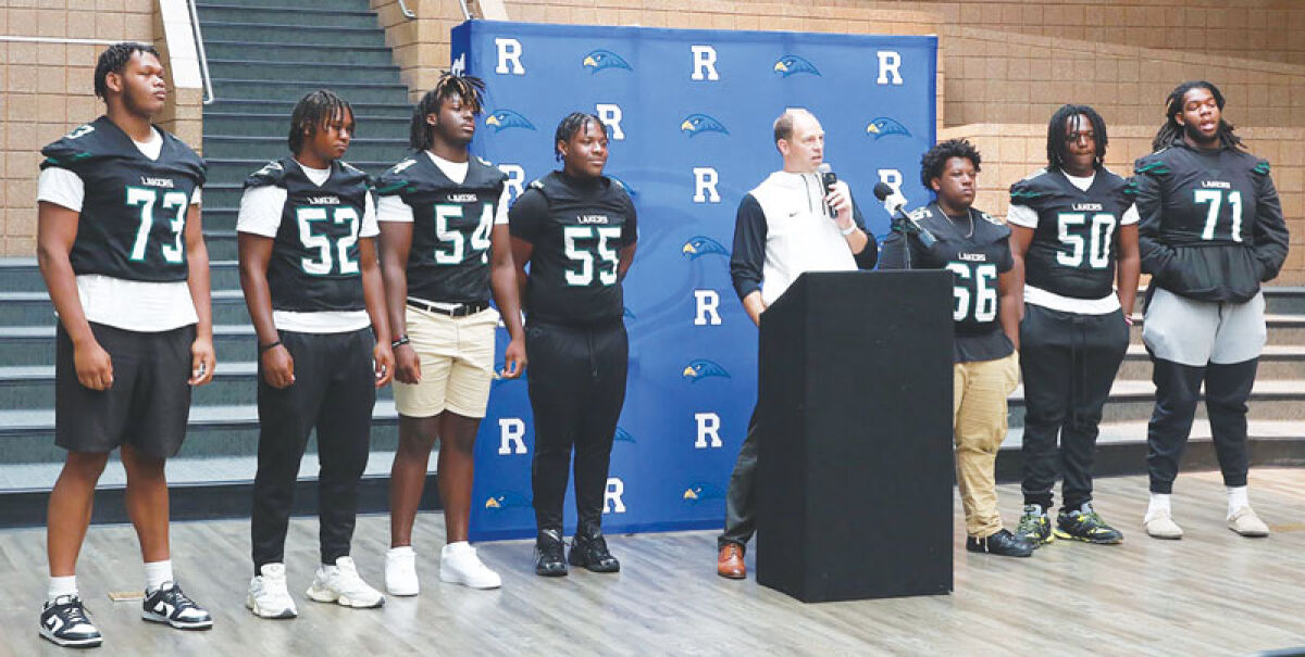  West Bloomfield head coach Zach Hilbers speaks with his offensive and defensive lines behind him at the Oakland Activities Association media day Aug. 9 at Rochester High School. 