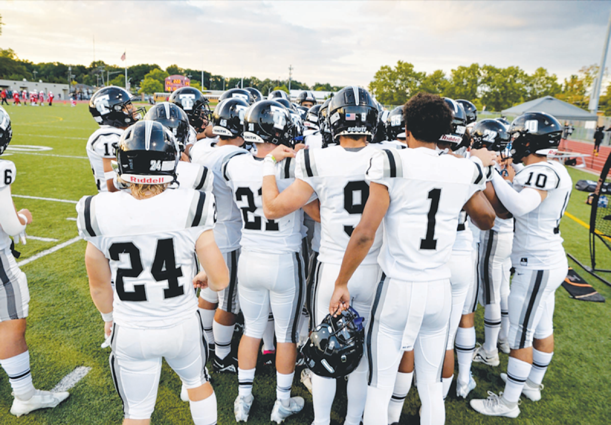  Troy huddles up during a game last season. 