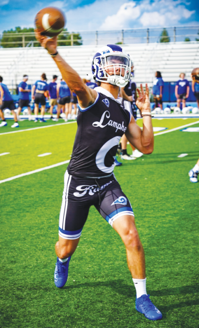  Madison Heights Lamphere senior quarterback Aidan Grzesikowski releases a pass during a team practice this year. 