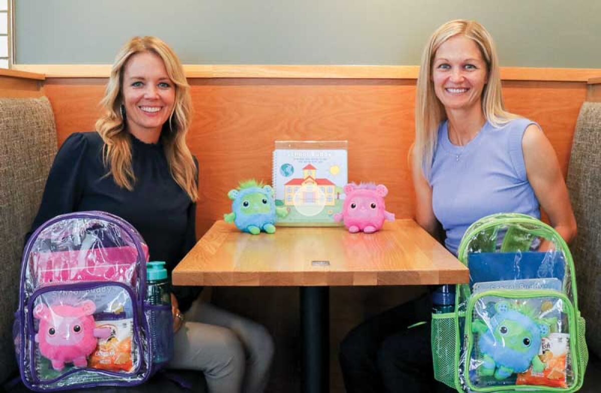  Sisters Carrah Wilczynski, of Macomb Township, left, and Callie Moylan, of Novi, show the School Buddy Adventure Set they created to help young children transition to school life. 