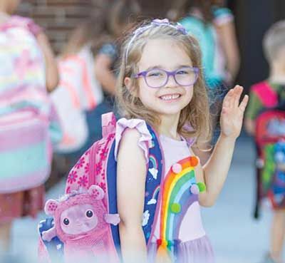  Kinsley Moylan waves goodbye to her parents as she starts her first day of kindergarten with her School Buddy in her backpack in the fall of 2023. 