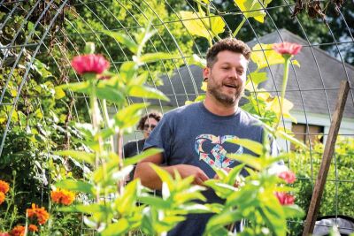  Tim Kniaz talks while standing among the plants at Urban Seed Community Garden Monday, Aug. 19, in Eastpointe. 