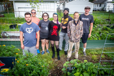  Members of the Urban Seed community pose for a portrait Aug. 19 in the Eastpointe garden. 