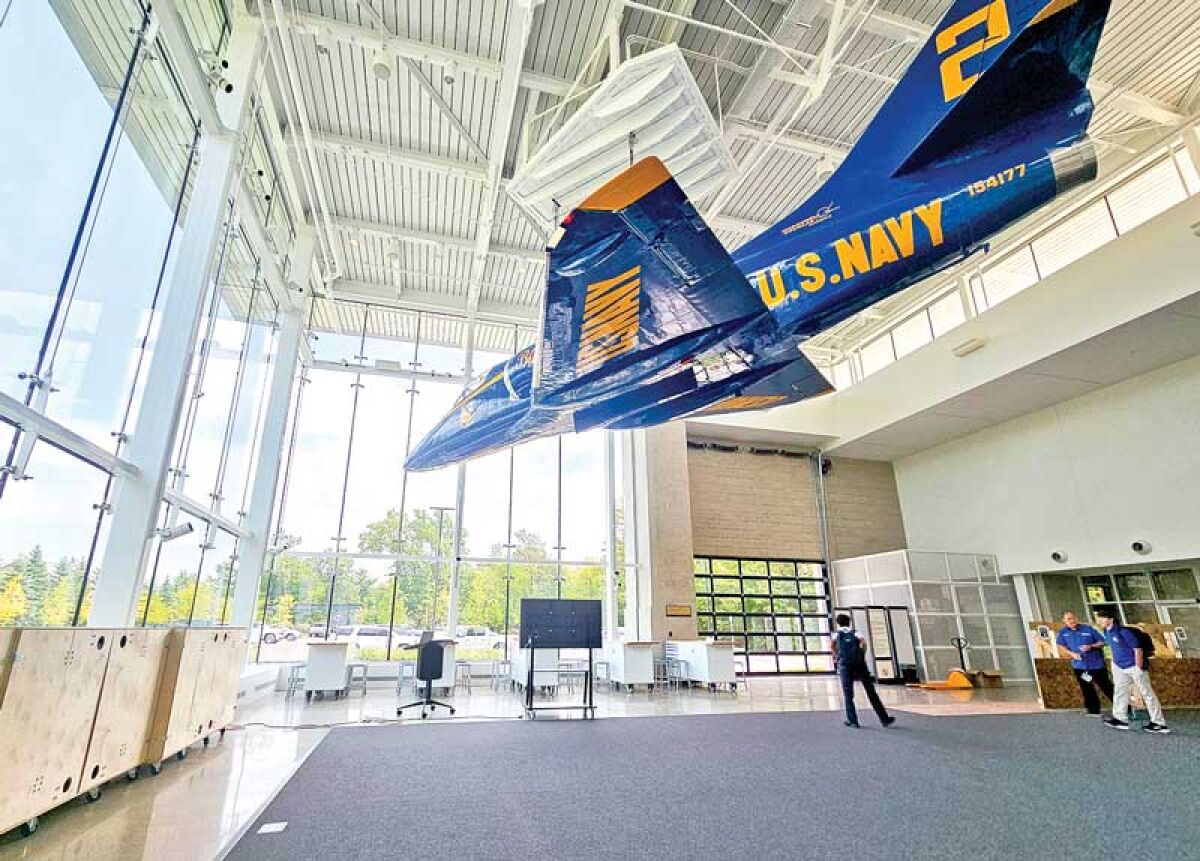  A retired U.S. Navy Blue Angels jet hangs from the ceiling above the new robotics competition field. 