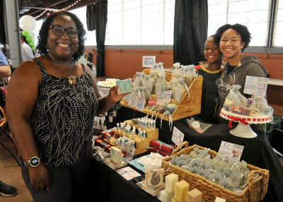  Camilla Rice is joined by her children, nine-year-old Miles and 17-year-old Selah, at her booth during the Diversity Expo.  