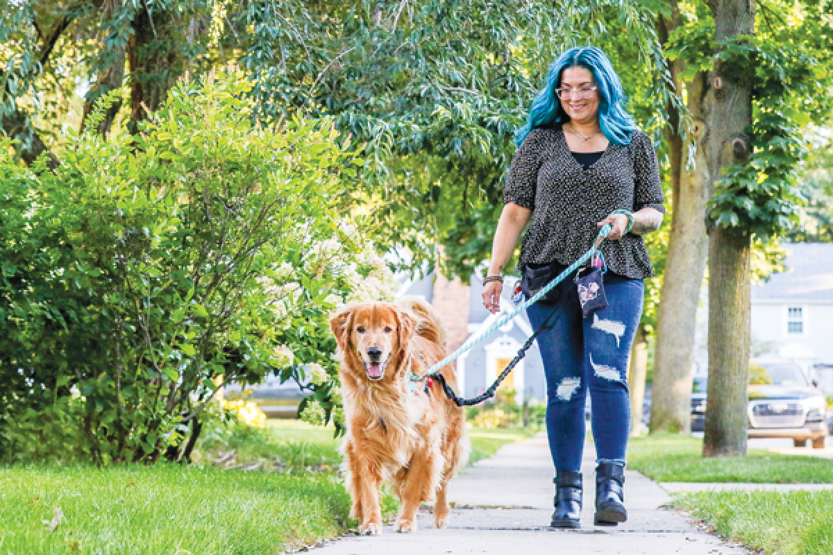  Alissa Sullivan, mayor pro tem of Hazel Park, walks Corey, a golden retriever belonging to a client of her pet care business. Sullivan has crafted an ordinance that will prohibit pet shops from selling a wide variety of species in Hazel Park. The goal is to crack down on “puppy mills” that are adding to the homeless  pet population 