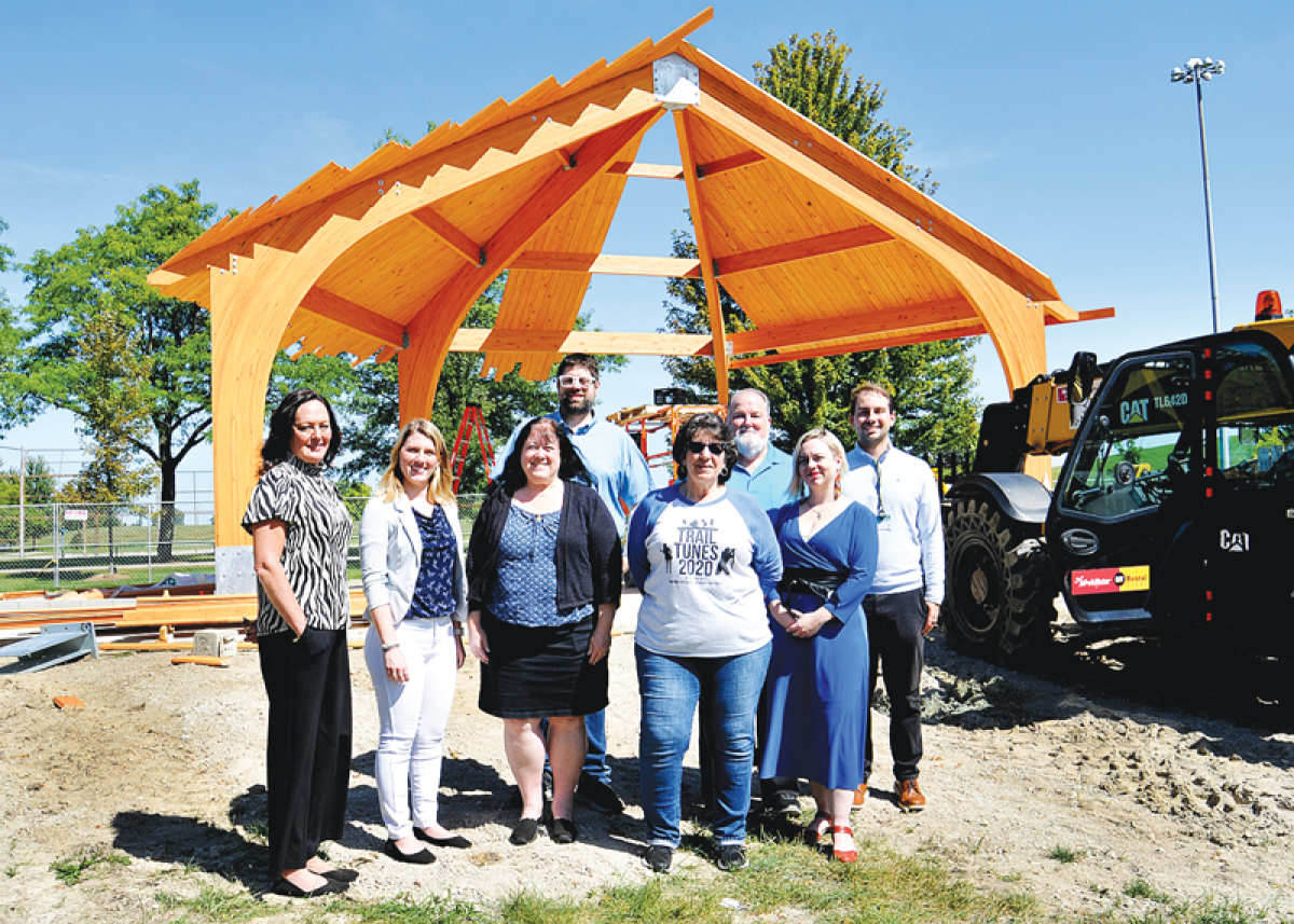  At the construction site of the bandshell at Civic Center Park in Madison Heights is, from left in front, City Manager Melissa Marsh, Harley Mordarski, Laurie Geralds, Vita Palazzolo, and Jennifer Nagle. Standing in the back is Mayor Pro Tem Mark Bliss, City Councilman Bill Mier, and Adam Owczarzak. The bandshell will make its debut at this year’s Trail Tunes, made possible by a Consumers Energy Foundation grant and the efforts of the volunteers on the Arts Board.  