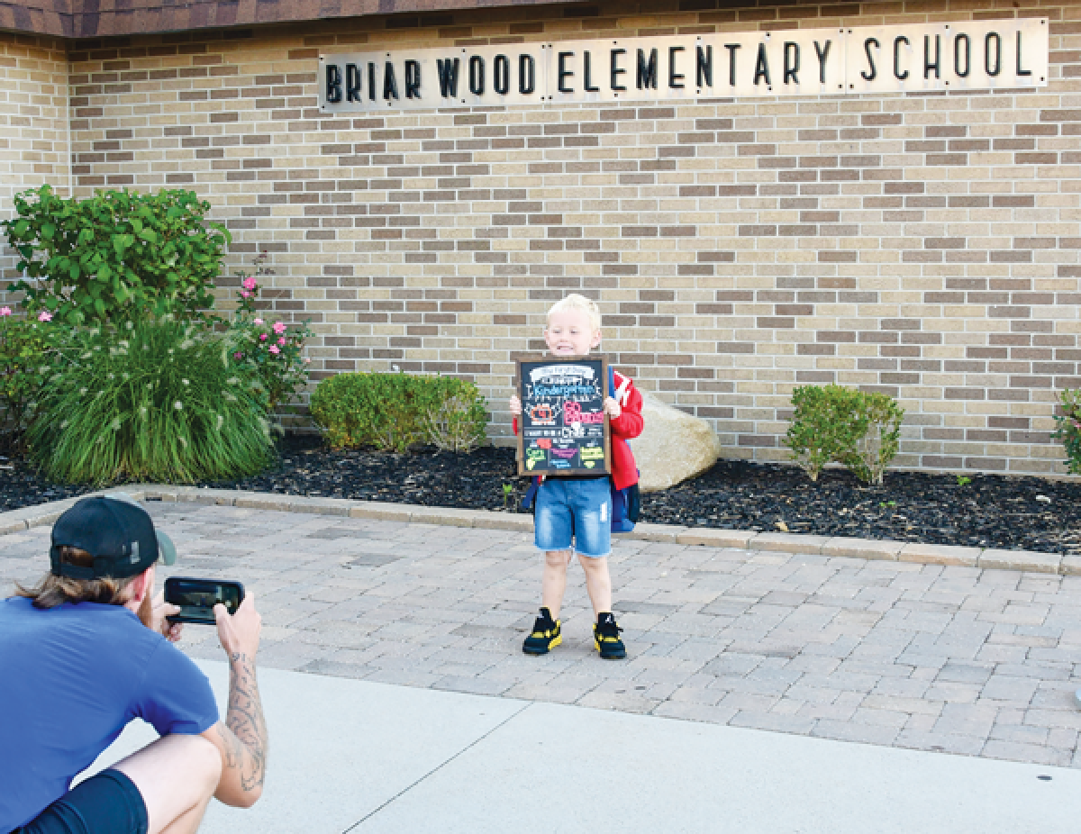  Five-year-old Briarwood Elementary student Liam Lane gets his picture taken by dad, David, on the first day of school.   