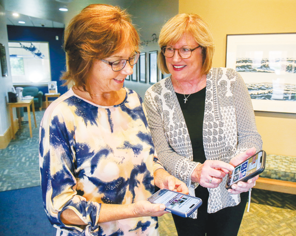  Bloomfield Township Senior Center Assistants Barb Modlin, left, and Mary Sue Sarzynski,  both Bloomfield Township residents, explore the new app. 