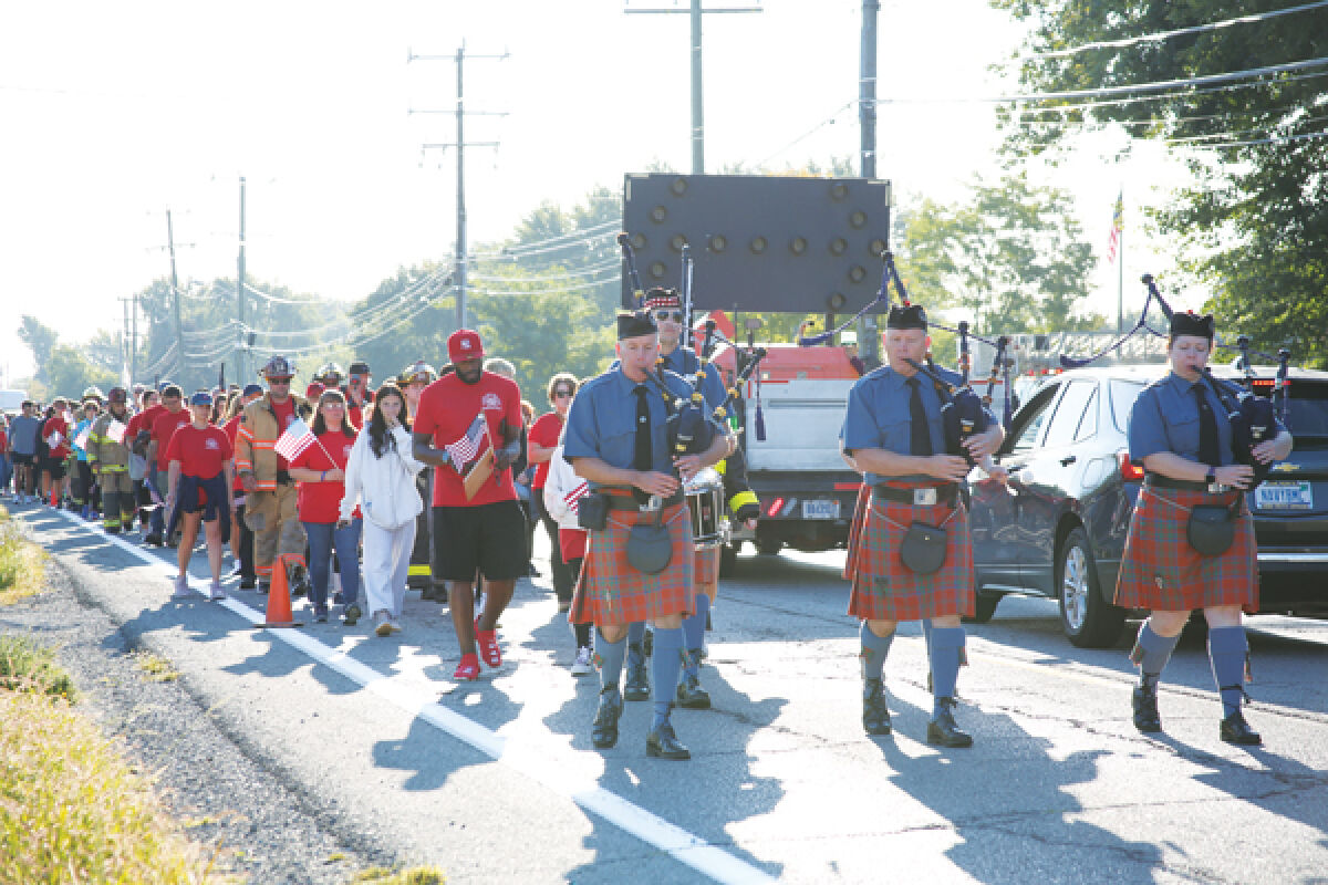  Bagpipers and drummers lead the first mile of Neighbors United’s 2024 #walkfortheRED down 21 Mile Road on Sept. 5. The walk covers 140 miles across the state of Michigan. 